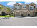 Inviting townhome features a three-car garage and a private balcony, enhancing its curb appeal at 8835 Moonlit Meadows Loop, Riverview, FL 33578