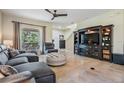 Comfortable living room with tile floors, fan, large media center, and large window at 19308 Sunset Bay Dr, Land O Lakes, FL 34638