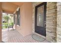 Cozy front porch features a decorative glass door and stone accents at 20312 Heritage Point Dr, Tampa, FL 33647