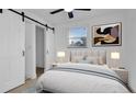 Cozy bedroom with natural light, closet with barn door, and soothing color palette at 2540 W Pine St, Tampa, FL 33607