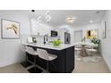 Stylish kitchen with stainless appliances, island with bar seating, and an adjacent dining area at 2540 W Pine St, Tampa, FL 33607