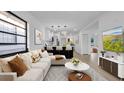 Bright, open living room featuring modern decor, hardwood floors and seamless flow into the kitchen at 2540 W Pine St, Tampa, FL 33607