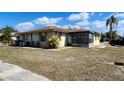 Charming single-story home with an enclosed patio and well-maintained landscaping at 5507 Riddle Rd, Holiday, FL 34690
