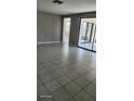 Spacious living room with tile floors and sliding glass doors at 5507 Riddle Rd, Holiday, FL 34690