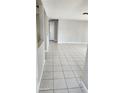 Bright living room featuring neutral walls and tile flooring at 5507 Riddle Rd, Holiday, FL 34690