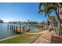 Dock on the harbor with easy access to the water, complemented by well-maintained landscaping and clear skies at 5836 Skimmer Point S Blvd, Gulfport, FL 33707