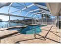 Enclosed pool with spa overlooking the harbor, perfect for relaxation and enjoying the waterfront scenery at 5836 Skimmer Point S Blvd, Gulfport, FL 33707