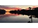 Waterfront community view at sunset featuring the serene harbor and colorful sky reflecting on the water at 5836 Skimmer Point S Blvd, Gulfport, FL 33707