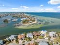 Breathtaking aerial view of a coastal community with beautiful waterfront homes and a sandy beach at 727 Key Royale Dr, Holmes Beach, FL 34217