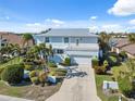 Stunning waterfront home with lush landscaping and a serene coastal ambiance at 727 Key Royale Dr, Holmes Beach, FL 34217