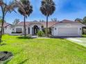 Lovely single-Gathering home with a well-kept lawn and charming landscaping at 8208 Rhanbuoy Rd, Spring Hill, FL 34606