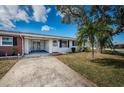 Cozy single-Gathering home with attached carport, blue shutters, and mature landscaping at 10022 Lily N St # N, Pinellas Park, FL 33782