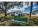 Charming single-story home with a well-maintained lawn, inviting bench and beautiful landscaping at 10022 Lily N St # N, Pinellas Park, FL 33782