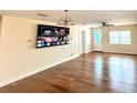 Spacious living room with hardwood floors, a ceiling fan, and neutral-colored walls for versatile decor at 4811 Haines N Rd, St Petersburg, FL 33714