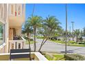 Inviting balcony overlooking a street with palm trees and tennis courts at 1200 N Shore Ne Dr # 204, St Petersburg, FL 33701