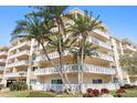 Beautiful condo building with multi-level balconies and lush landscaping at 1200 N Shore Ne Dr # 204, St Petersburg, FL 33701