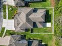 Aerial view of the home showing the roof, backyard, and driveway at 4446 Wildstar Cir, Wesley Chapel, FL 33544