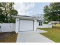 Single-Gathering home boasting a well-manicured lawn and two-car garage at 9404 N 12Th St, Tampa, FL 33612