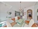 Bright dining area with a glass-top table set and chandelier, open to the living areas for easy entertaining at 13024 Prestwick Dr, Riverview, FL 33579