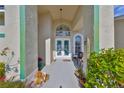 Elegant entryway features double doors with decorative glass and tiled floors, welcoming visitors into the home at 13024 Prestwick Dr, Riverview, FL 33579
