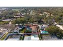 Aerial view of a single-Gathering home with a private pool surrounded by lush greenery at 1883 Brae Moor Dr, Dunedin, FL 34698