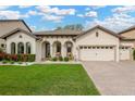 Charming single-Gathering home with lush front yard, well manicured landscaping, and a welcoming front porch at 2677 Northwood Park St, Valrico, FL 33596