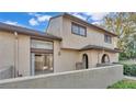 Two story condo building featuring a fenced patio with sliding glass doors at 6262 142Nd Ave # 506, Clearwater, FL 33760