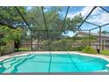 A screened-in pool provides a private oasis with clear water and ample space for relaxation and recreation at 11209 Bloomington Dr, Tampa, FL 33635