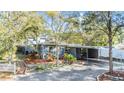 Charming home featuring a covered carport, attractive landscaping, and a welcoming front entrance at 1157 Brook Rd, Clearwater, FL 33755