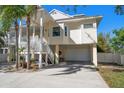 Charming elevated home featuring an attached two-car garage and inviting staircase at 14554 90Th Ave, Seminole, FL 33776