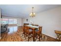Dining room with hardwood floors, chandelier and view into living room at 3010 59Th S St # 303, Gulfport, FL 33707