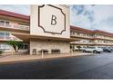Exterior full view of condo building B, with visible parking and seating at 3010 59Th S St # 303, Gulfport, FL 33707