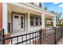 Charming covered entrance with classic columns and black metal fence detailing at 4142 N Nebraska Ave, Tampa, FL 33603