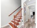 Elegant wooden staircase with a classic design and bright, neutral walls at 4142 N Nebraska Ave, Tampa, FL 33603