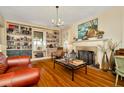 Spacious living room featuring hardwood floors, built-in bookshelves, and a fireplace at 417 W Davis Blvd, Tampa, FL 33606