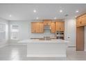 Bright, open kitchen boasts a large island, modern appliances, stylish cabinetry, and sleek countertops, perfect for cooking at 9306 Torrent Trail Ct, Sarasota, FL 34241