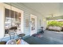Inviting front porch with comfortable seating, creating a perfect outdoor living space with a view at 306 S Albany Ave, Tampa, FL 33606