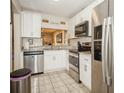 Bright kitchen with stainless steel appliances, white cabinets, and granite countertops at 5100 Burchette Rd # 306, Tampa, FL 33647