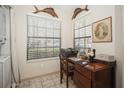 Cozy office space with a desk, artwork, and natural light from a window at 5100 Burchette Rd # 306, Tampa, FL 33647