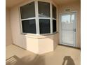 Enclosed porch featuring neutral paint color, corner window, and front door with storm door at 6315 Shoreline Dr # 3204, Seminole, FL 33708