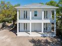 Striking two-story white home features a double porch and an inviting exterior design at 1119 26Th N Ave, St Petersburg, FL 33704