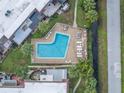 Aerial view of a community pool surrounded by lounge chairs and palm trees at 1370 70Th N St # 2-1382, St Petersburg, FL 33710