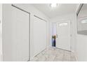 Bright entryway featuring marble floors, multiple closets, and a front door with decorative glass inserts at 16109 Northglenn Dr, Tampa, FL 33618