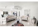 Open-concept living room with marble floors, modern furniture, and abundant natural light at 16109 Northglenn Dr, Tampa, FL 33618