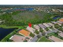 Aerial view of home highlighting lush surroundings and nearby lakes at 16135 Cape Coral Dr, Wimauma, FL 33598
