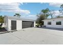 Spacious detached garage with a roll up door provides ample parking and storage at 8376 Sycamore Dr, New Port Richey, FL 34654