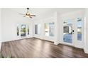 Bright living room featuring wood flooring and neutral walls, offering a versatile and comfortable living space at 8376 Sycamore Dr, New Port Richey, FL 34654