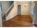 Bright dining room featuring wood floors and a modern chandelier at 11713 Summer Springs Dr, Riverview, FL 33579