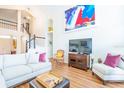 Inviting living room features wood floors, comfortable seating, and a staircase to the upper level at 18934 Avenue Biarritz, Lutz, FL 33558