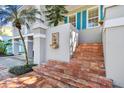Close up of brick stairs leading to front porch with decorative fountain at 2508 W Shell Point Rd, Tampa, FL 33611